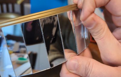 Jon Beaton applying mirrors to the central column of his praxinoscope.